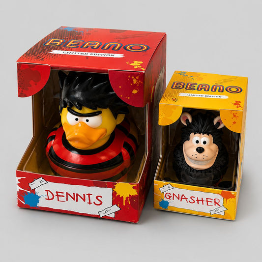 Two rubber ducks, Dennis and Gnasher, in their packaging with 'Beano' branding on a gray background.